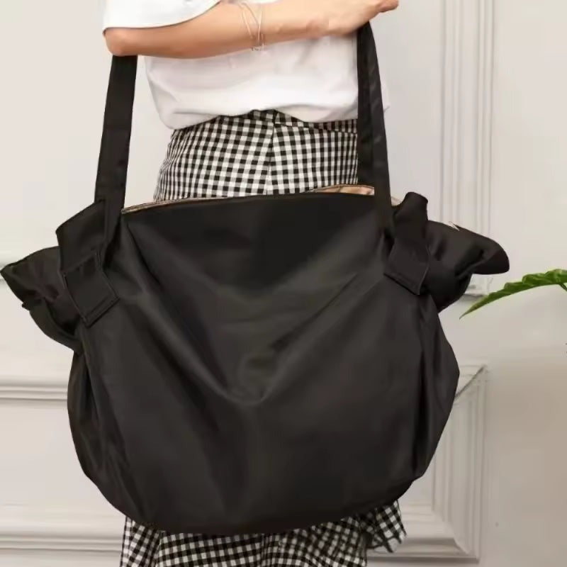 Bodega Bag in Bodega Black worn as a tote over the shoulder