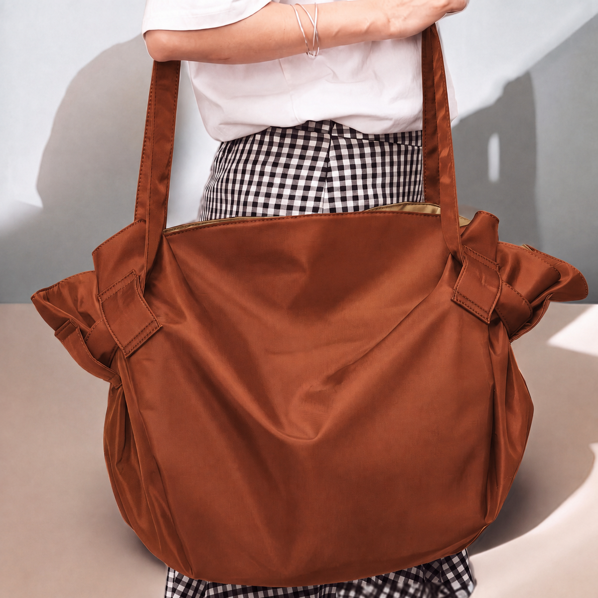 Bodega Bag in Espresso Brown worn as a tote over the shoulder